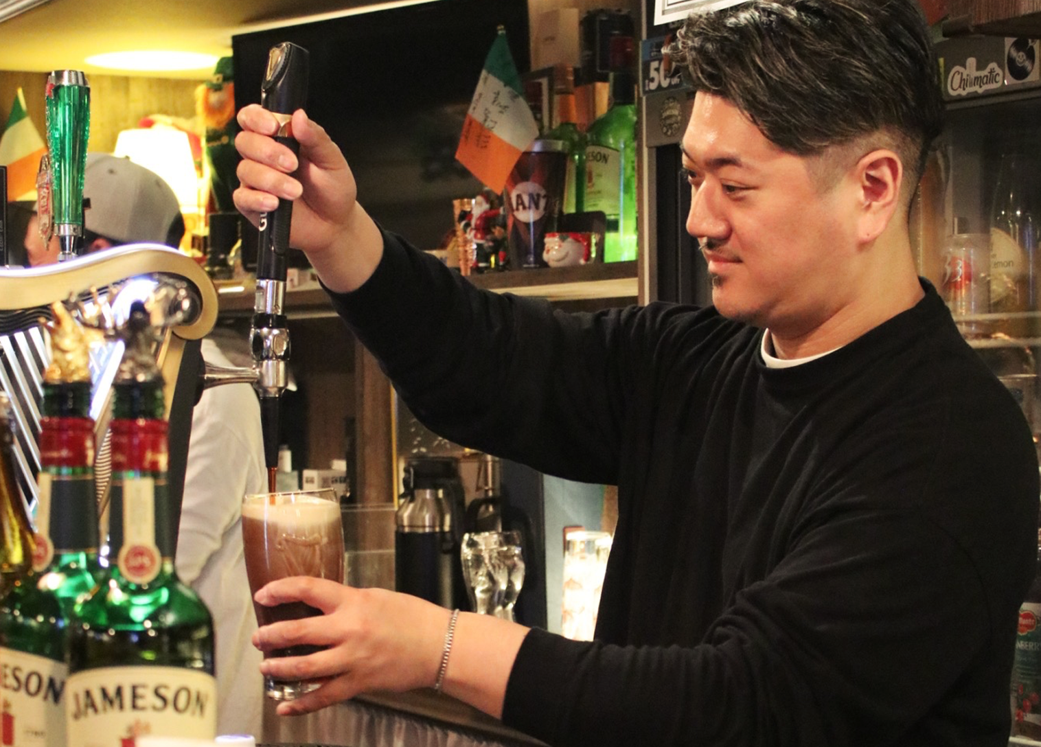 The owner pours beer